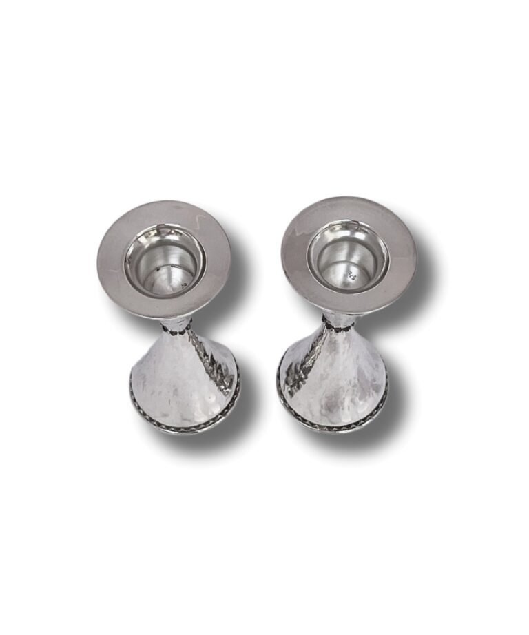 Top view of silver candle holders with wide rims and hammered texture