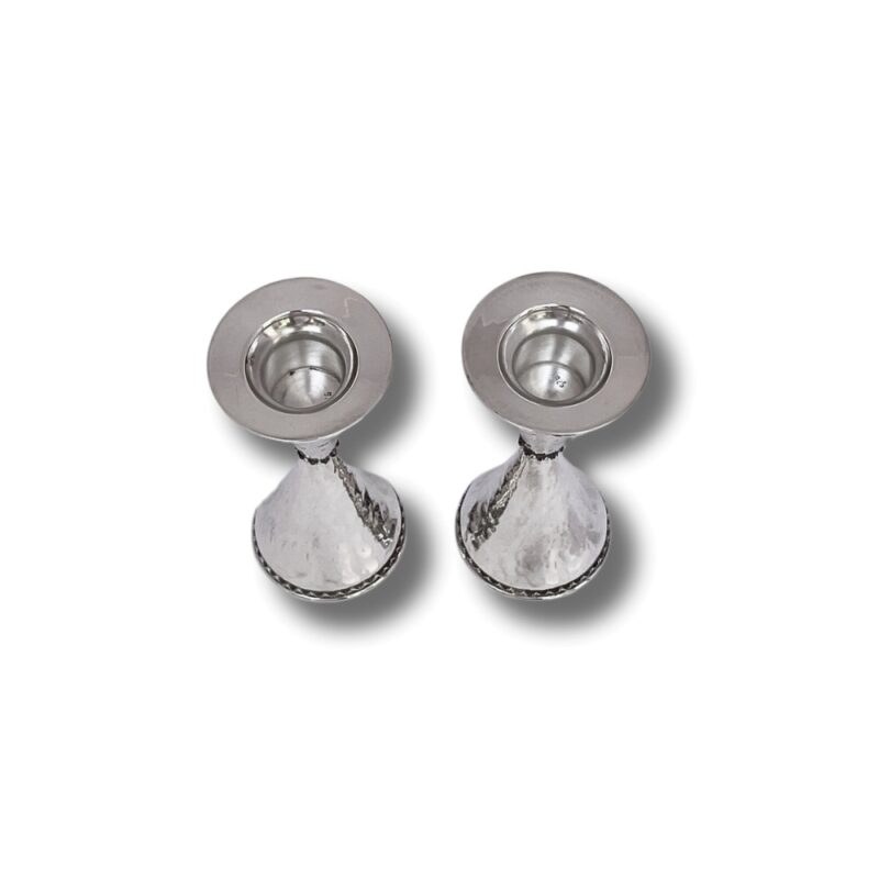 Top view of silver candle holders with wide rims and hammered texture