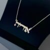 Close-up of 14K Solid Gold Hebrew Name Necklace against a dark backdrop