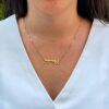 Elegant necklace worn close to neckline in natural light