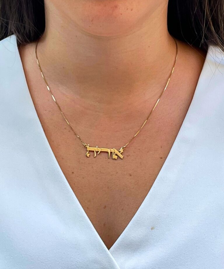 Elegant necklace worn close to neckline in natural light