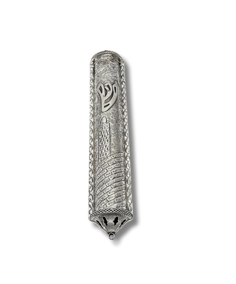 Close-up of raised Shin symbol on decorative silver mezuzah with Jerusalem motif