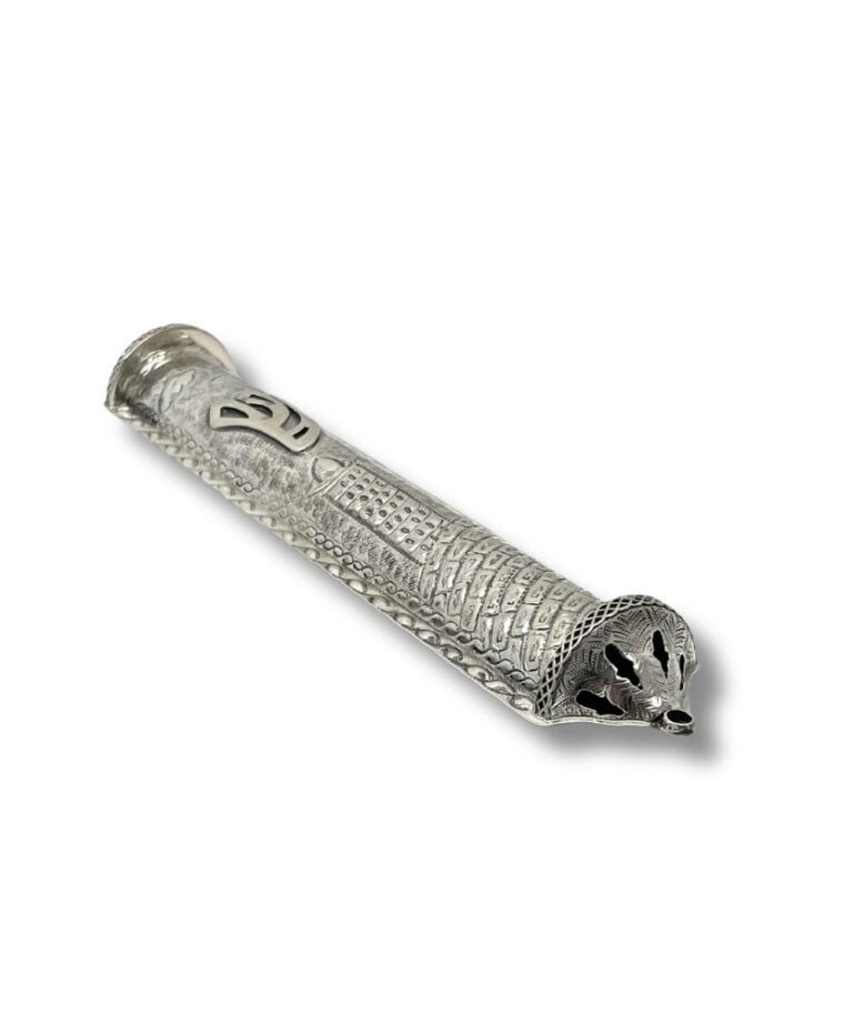 Angled side view of handcrafted silver mezuzah showing ornamental base