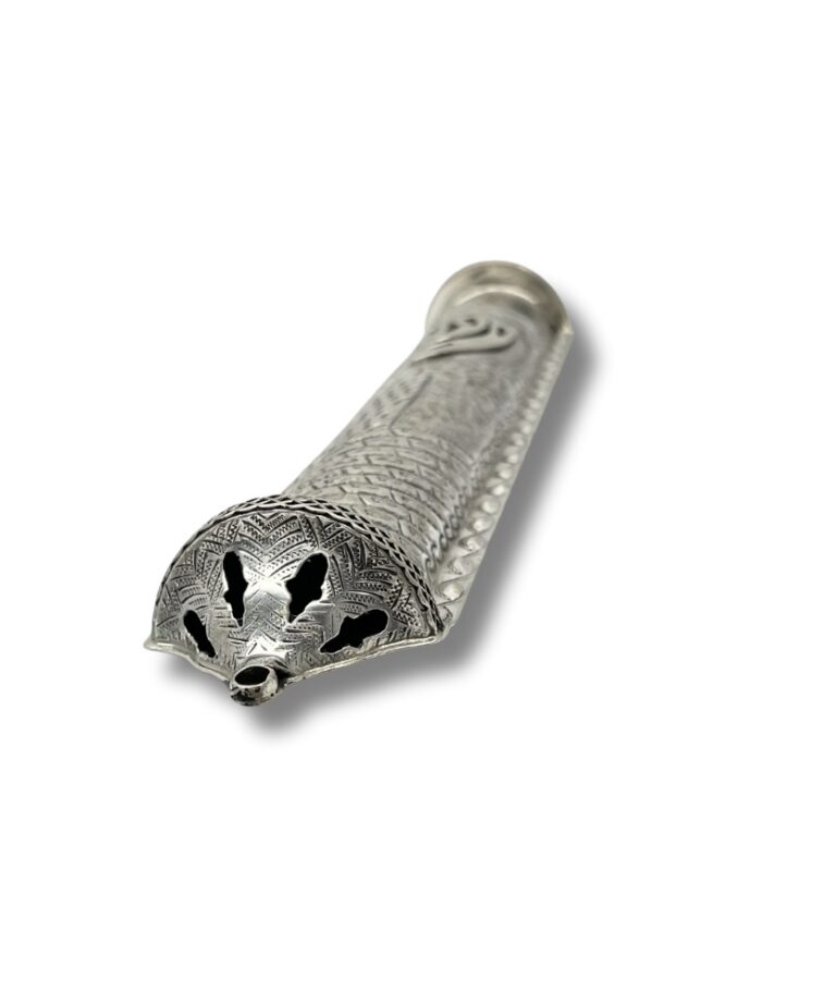 Detailed view of mezuzah end cap with engraved patterns and cut-out design
