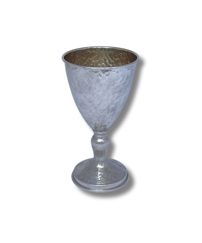 Hammered silver goblet with a rounded base and golden interior