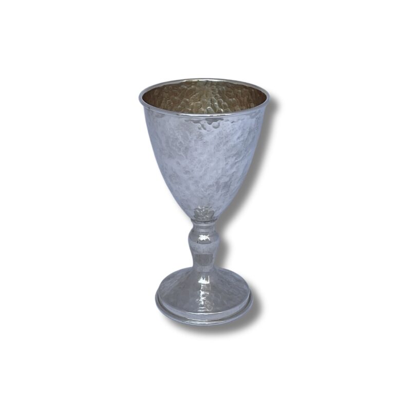 Hammered silver goblet with a rounded base and golden interior