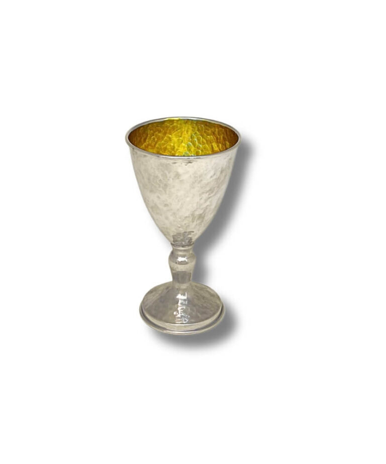 Hammered silver goblet with a rounded base and golden interior