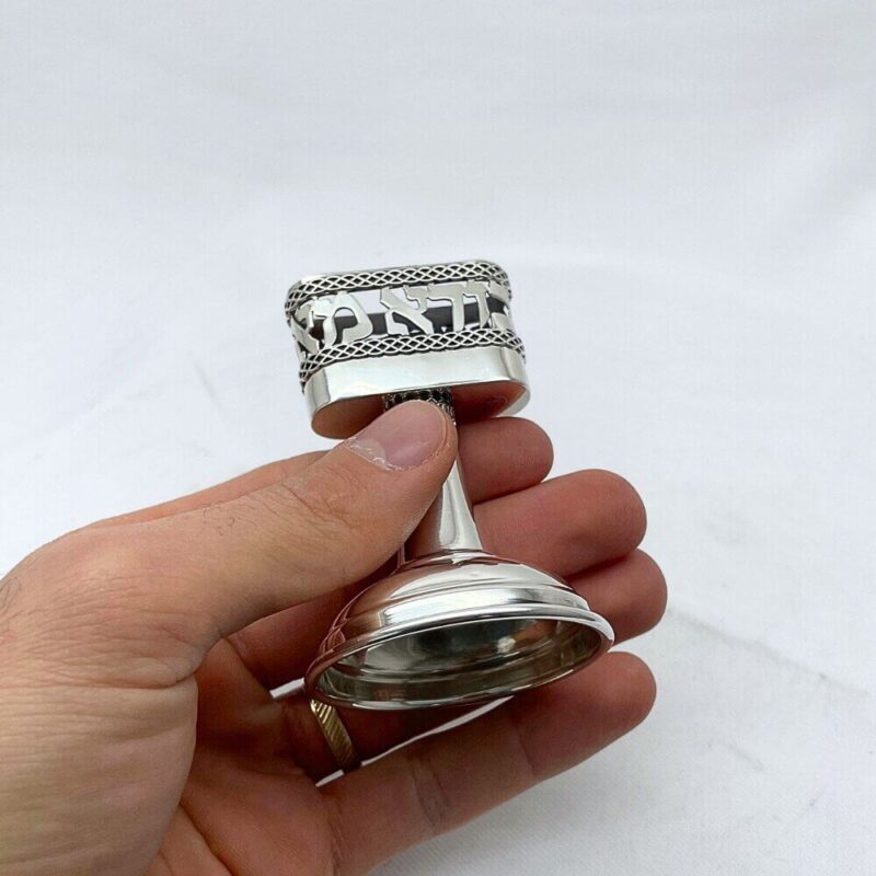 hand holding Havdalah Candle Holder with Hebrew inscription