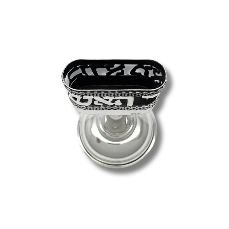 Top view of silver candle holder with intricate cut-out design