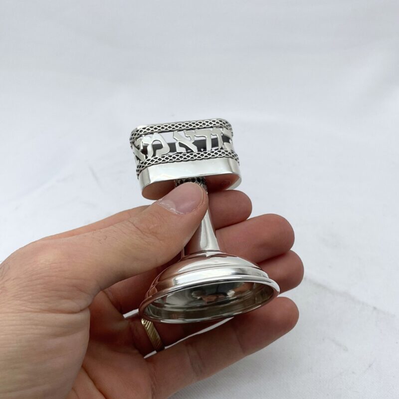 hand holding Havdalah Candle Holder with Hebrew inscription