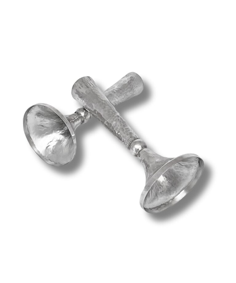 Angled display of hammered silver Shabbat candlesticks