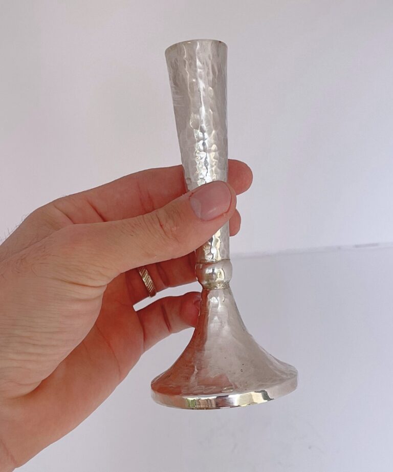 Hand holding Hammered Candlestick showcasing texture