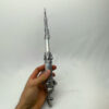 Hand holding a traditional Torah pointer for scale