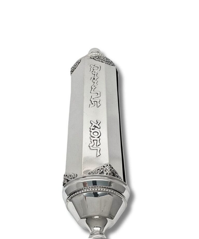 Close-up of engraved 'Megillat Esther' Hebrew letters on polished silver case