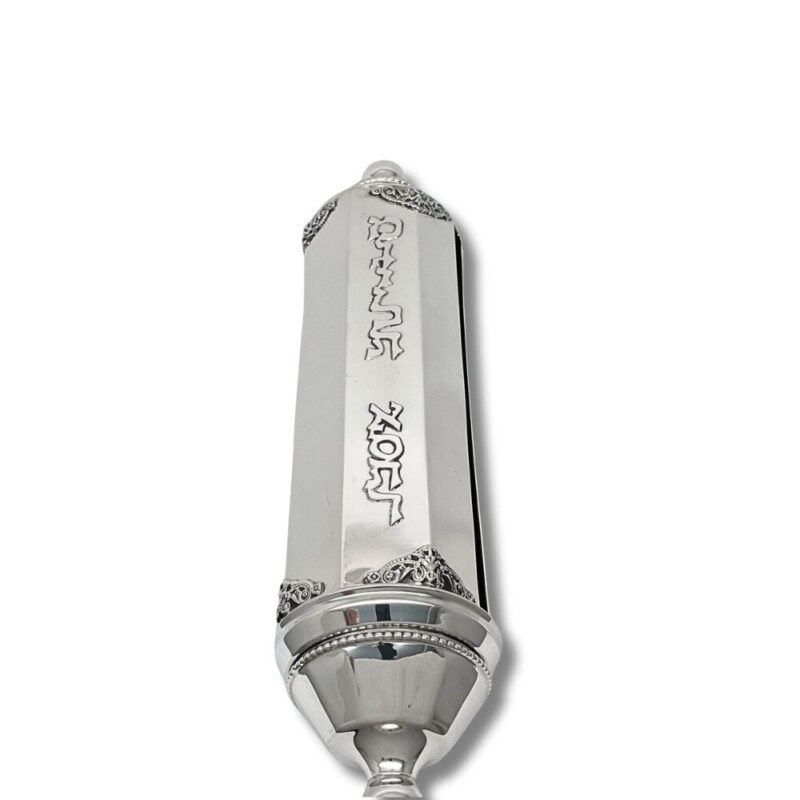 Close-up of engraved 'Megillat Esther' Hebrew letters on polished silver case