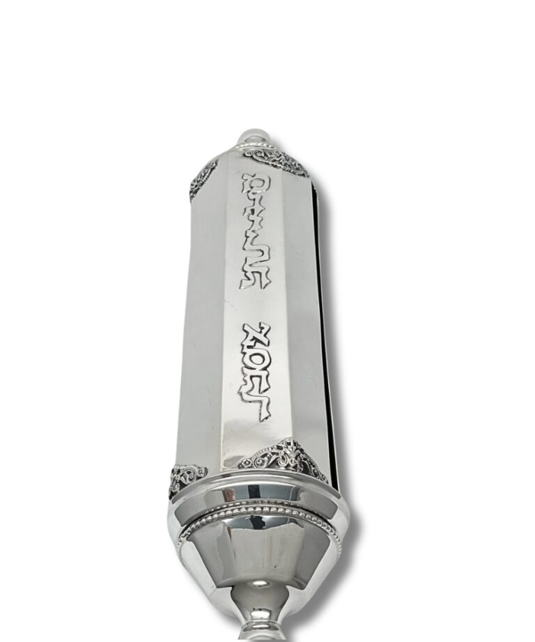 Close-up of engraved 'Megillat Esther' Hebrew letters on polished silver case