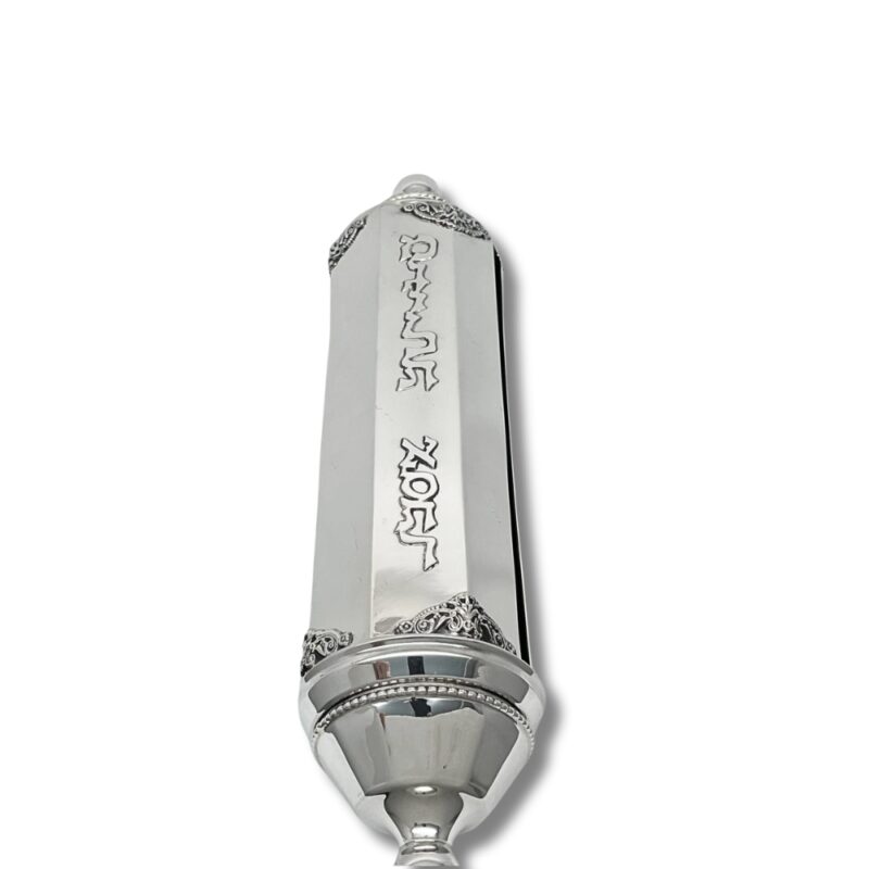 Close-up of engraved 'Megillat Esther' Hebrew letters on polished silver case