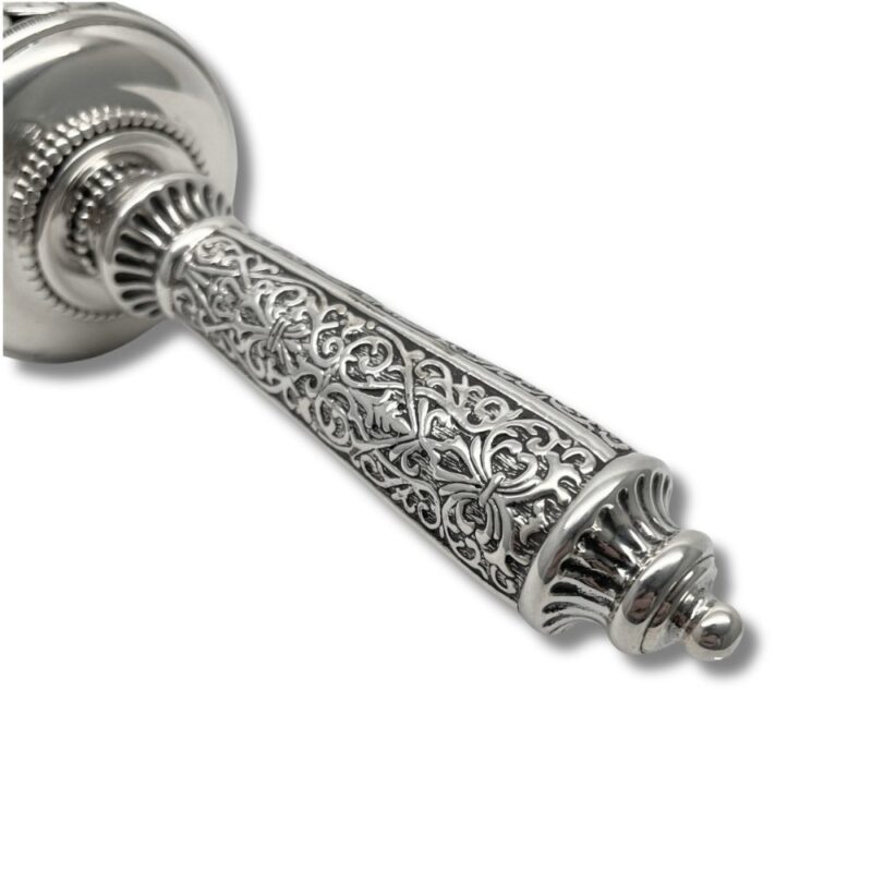 Close-up of the detailed silverwork on the handle with vine and floral patterns
