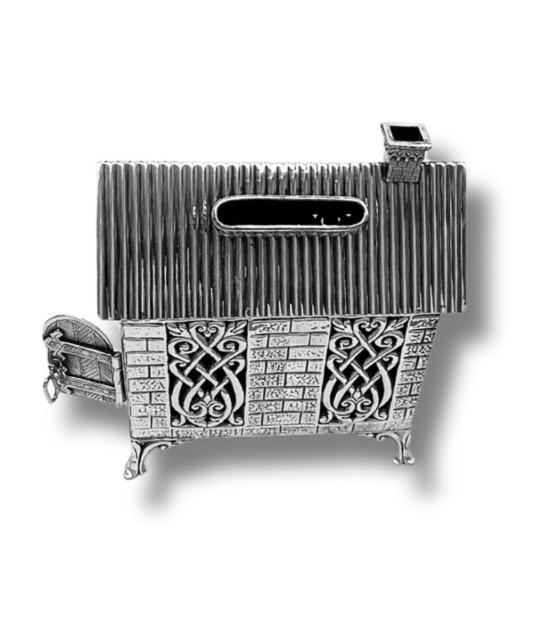 Top view of Tzedakah box showing coin slot and ornate roof design