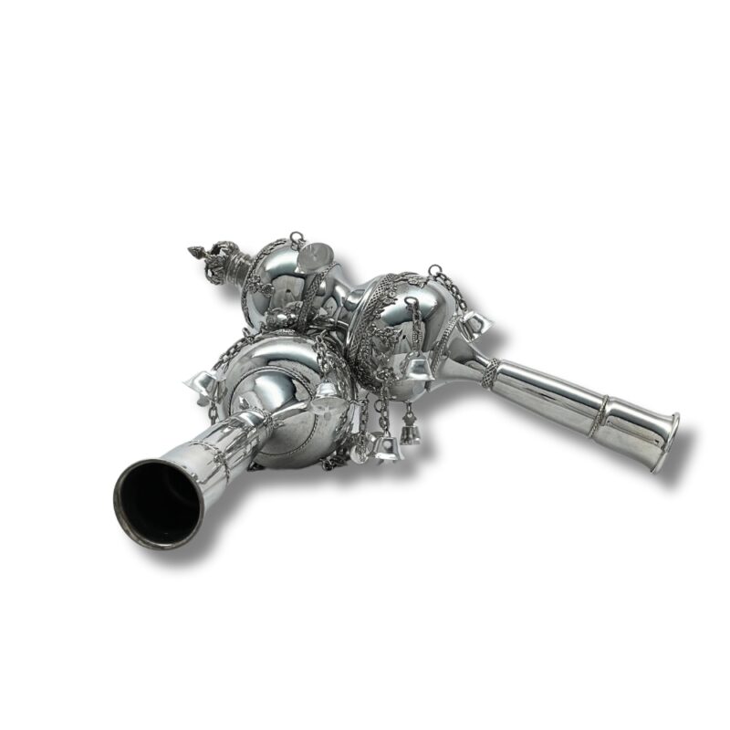 Detailed side view of silver Torah Rimonim with bells and traditional engraving