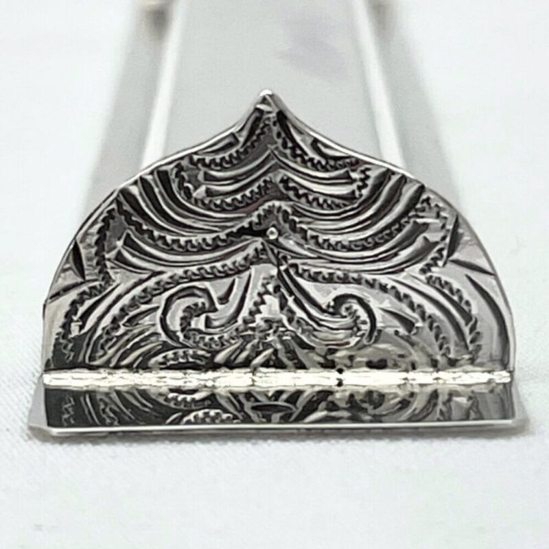 Detailed engraving on the decorative bottom of the mezuzah case in floral oriental style