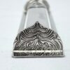 Detailed engraving on the decorative bottom of the mezuzah case in floral oriental style