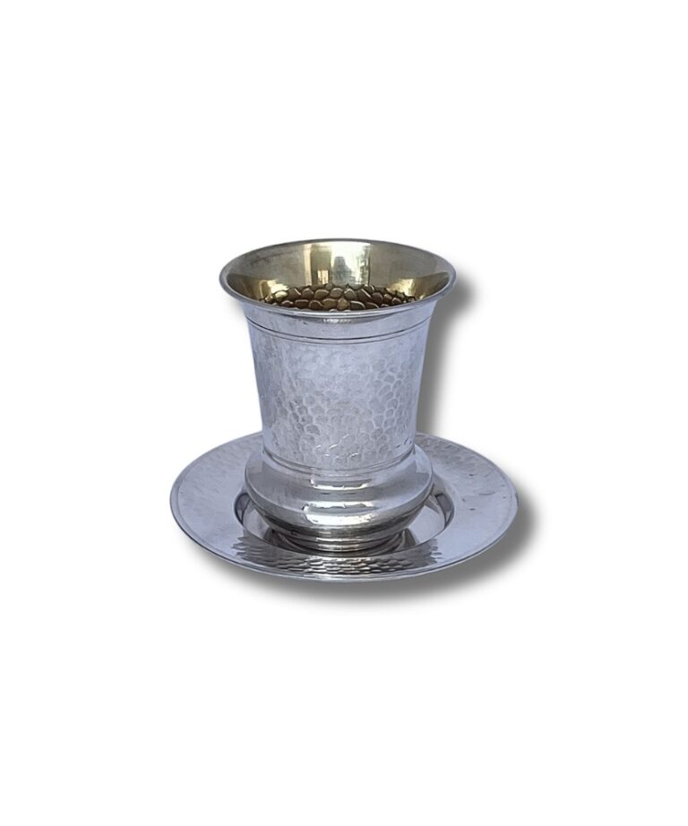 Side view of a 925 Sterling Silver Hammered Kiddush Cup, placed on a matching silver plate, showcasing the hammered texture and elegant shape.