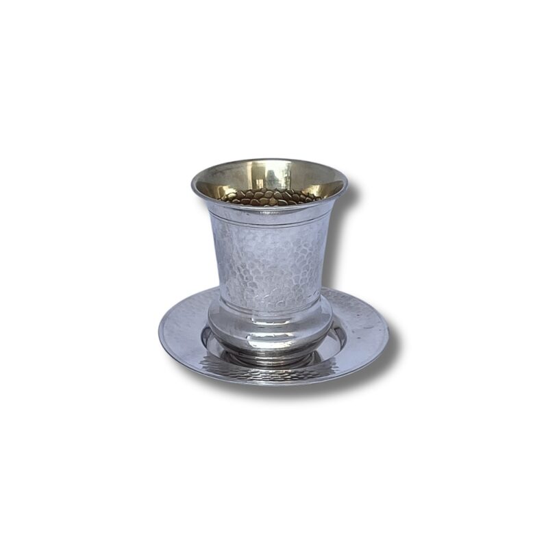 Side view of a 925 Sterling Silver Hammered Kiddush Cup, placed on a matching silver plate, showcasing the hammered texture and elegant shape.