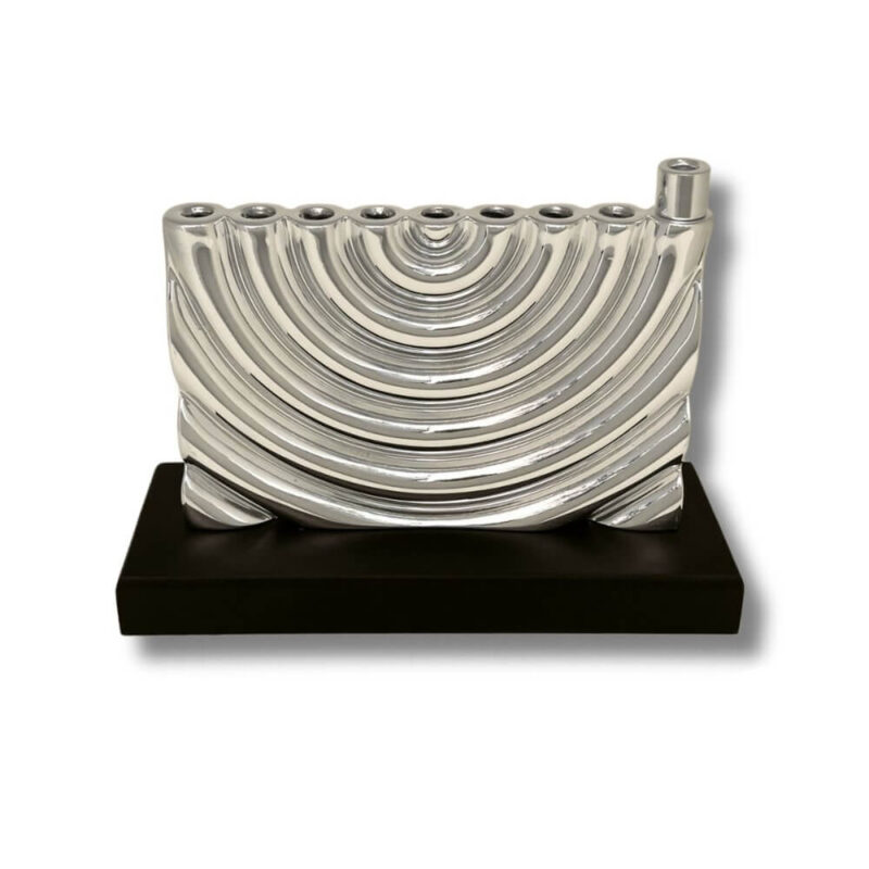 Front view of curved silver menorah with smooth finish and solid base