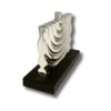 Side view of a modern silver Hanukkah candle holder on black wood base