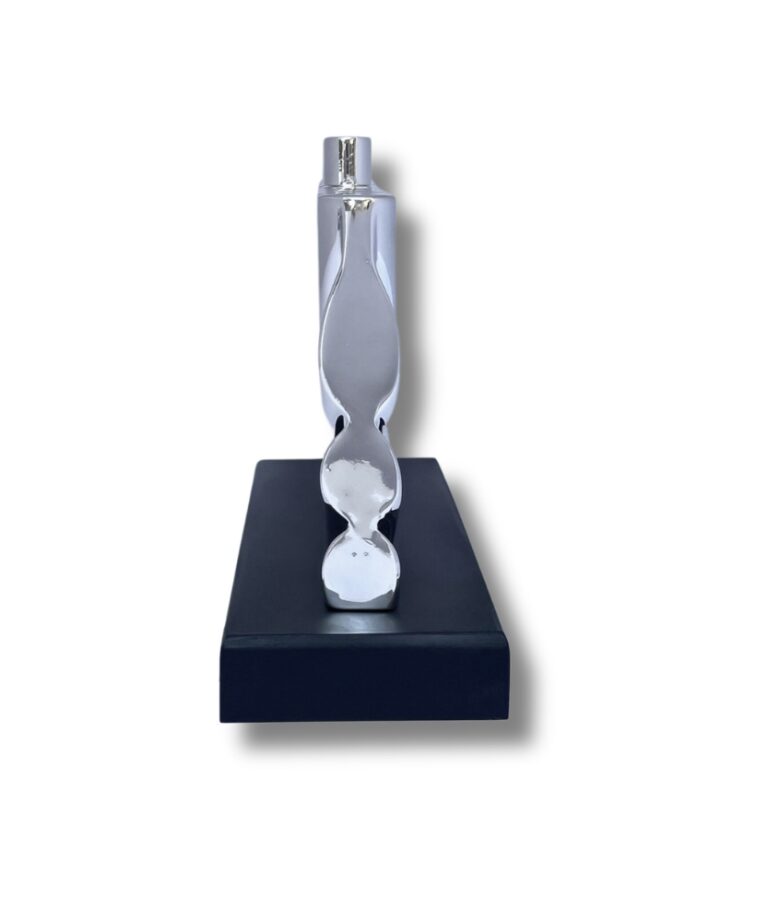 Side view of a modern silver Hanukkah candle holder on black wood base