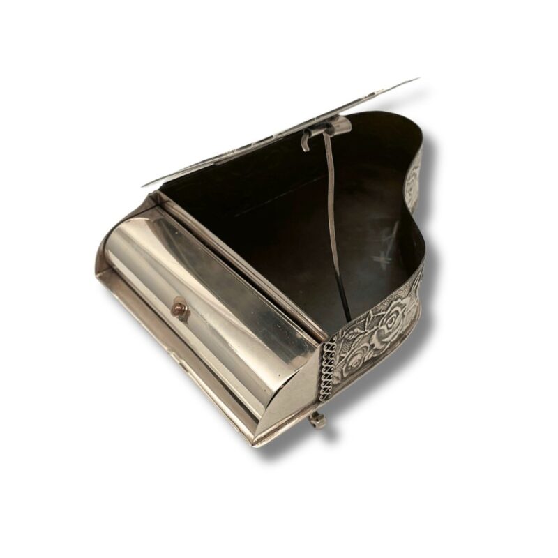 Interior of an open spice box showing the piano-style lid and empty compartment