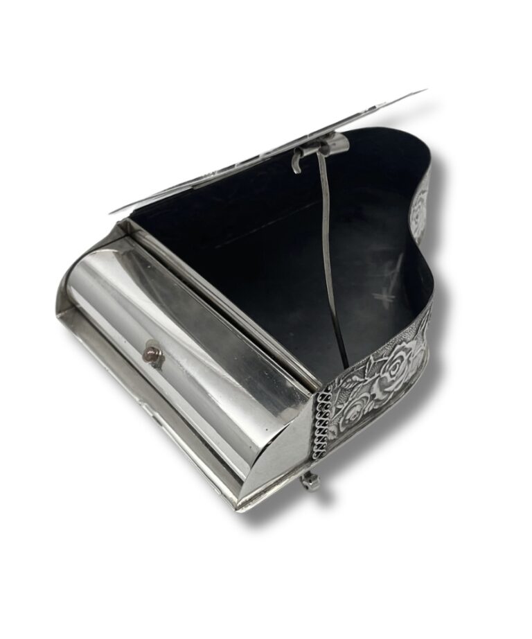 Interior of an open spice box showing the piano-style lid and empty compartment
