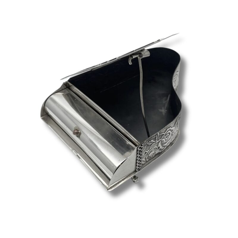 Interior of an open spice box showing the piano-style lid and empty compartment