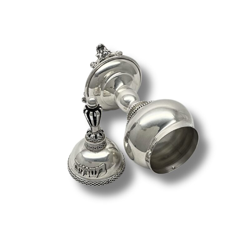 Side view of silver Besamim Box lying flat, highlighting the engraved Hebrew text 'בשמים' and the detailed silverwork around the body