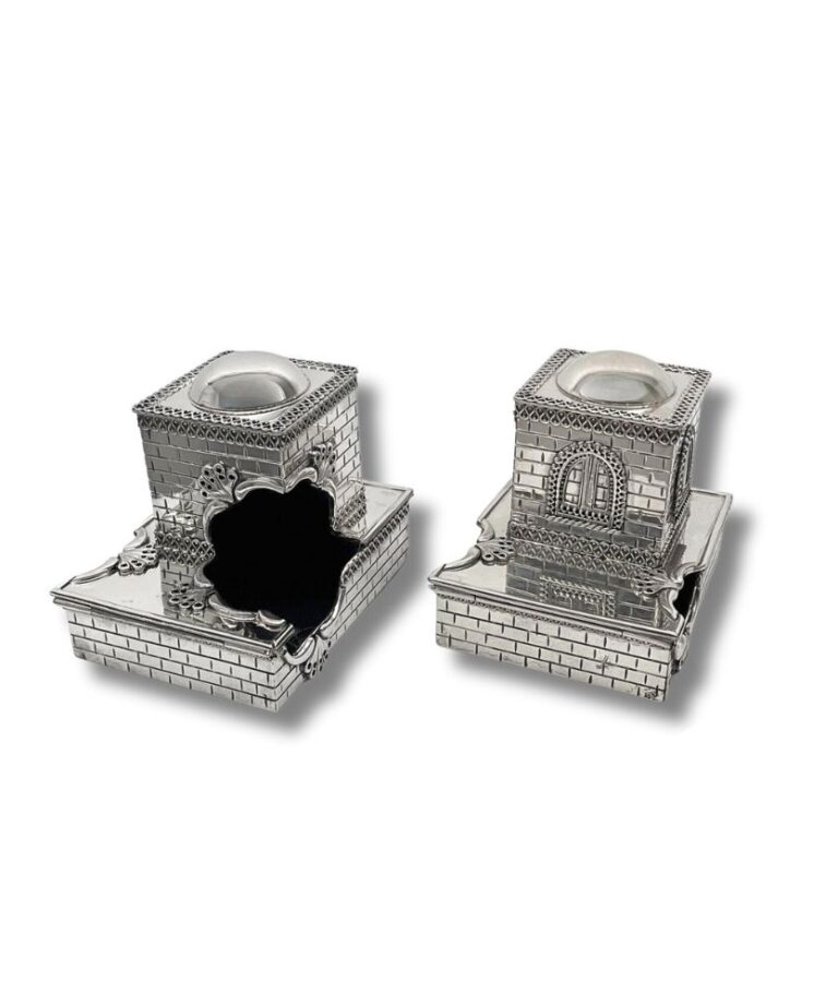 Open view of silver tefillin boxes showcasing interior detail and unique architectural style