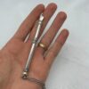 Sterling silver small Torah pointer with chain displayed on hand