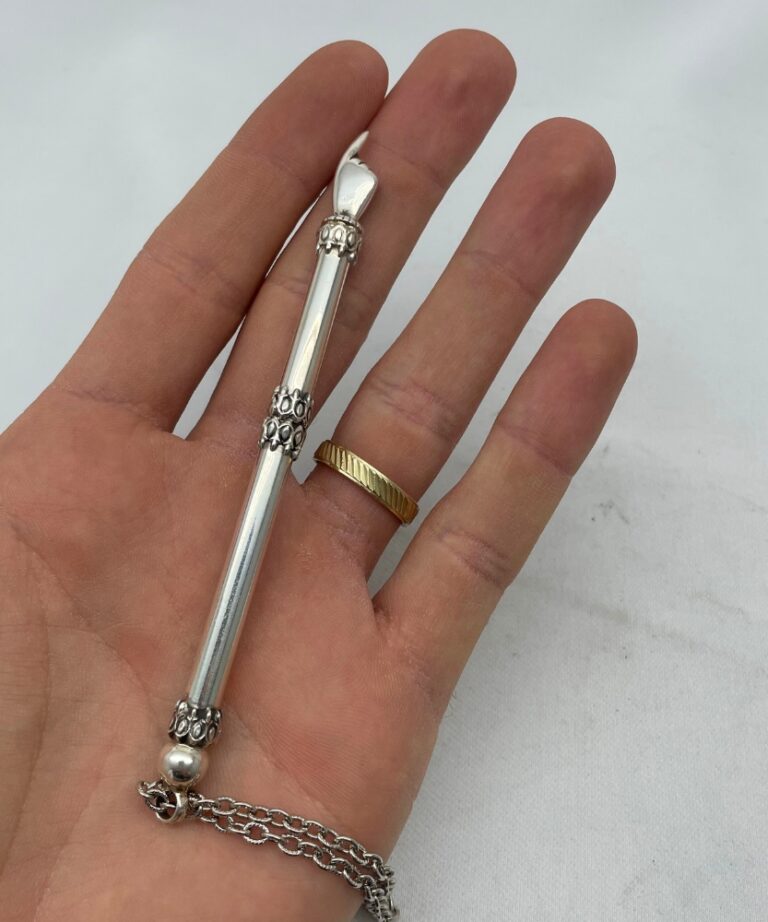 Sterling silver small Torah pointer with chain displayed on hand