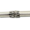 Close-up of decorative silver engravings on Torah pointer