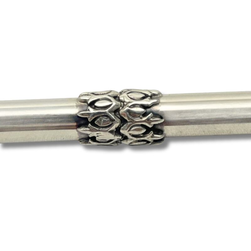 Close-up of decorative silver engravings on Torah pointer