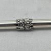 Close-up of decorative silver engravings on Torah pointer