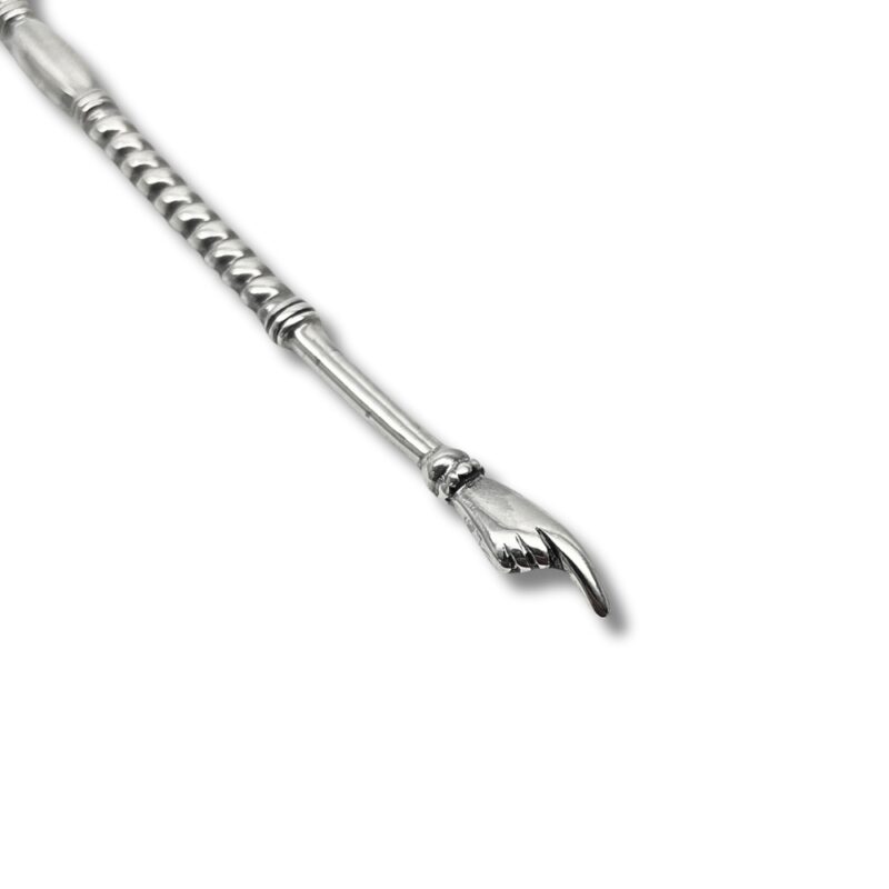Close-up of the hand-shaped tip on a silver Torah pointer
