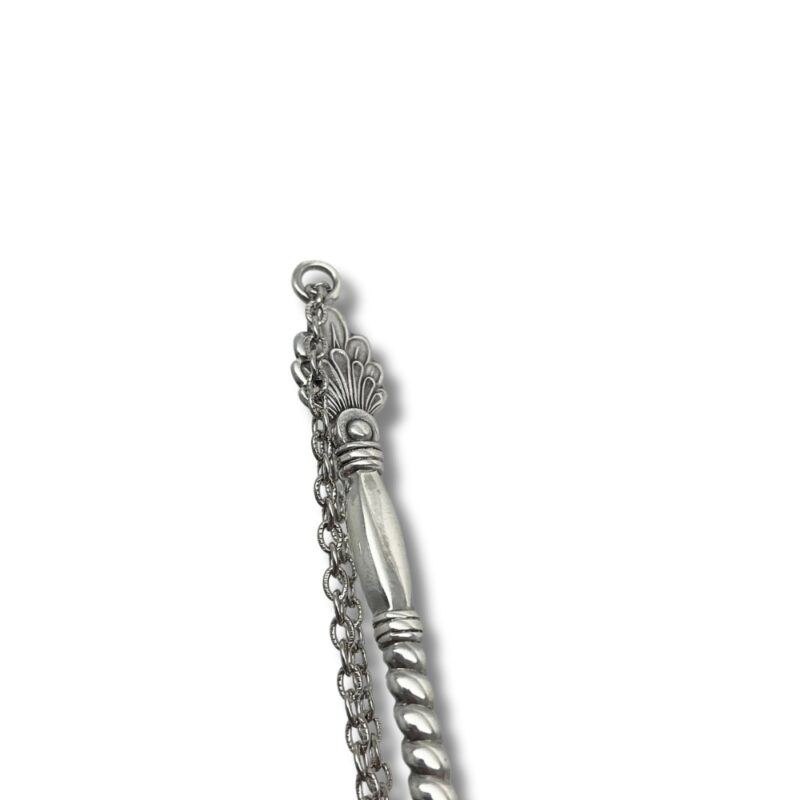 Decorative silver Yad handle with attached chain on white background