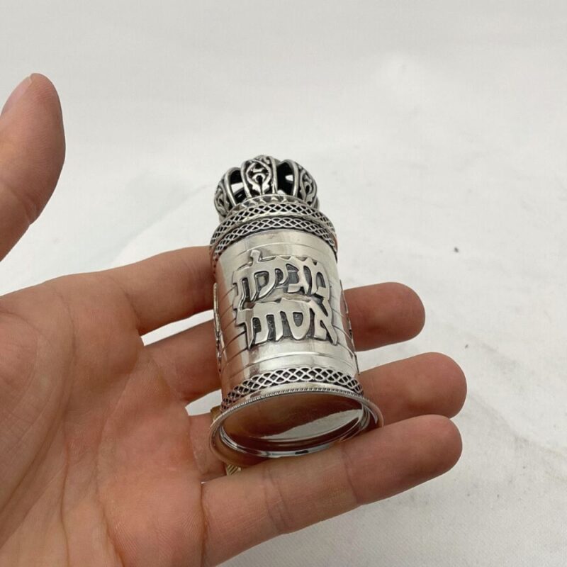 Small Judaica scroll case held in hand to show scale and craftsmanship
