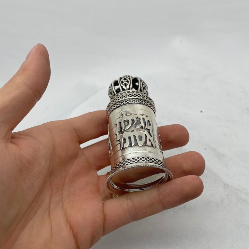 Small Judaica scroll case held in hand to show scale and craftsmanship