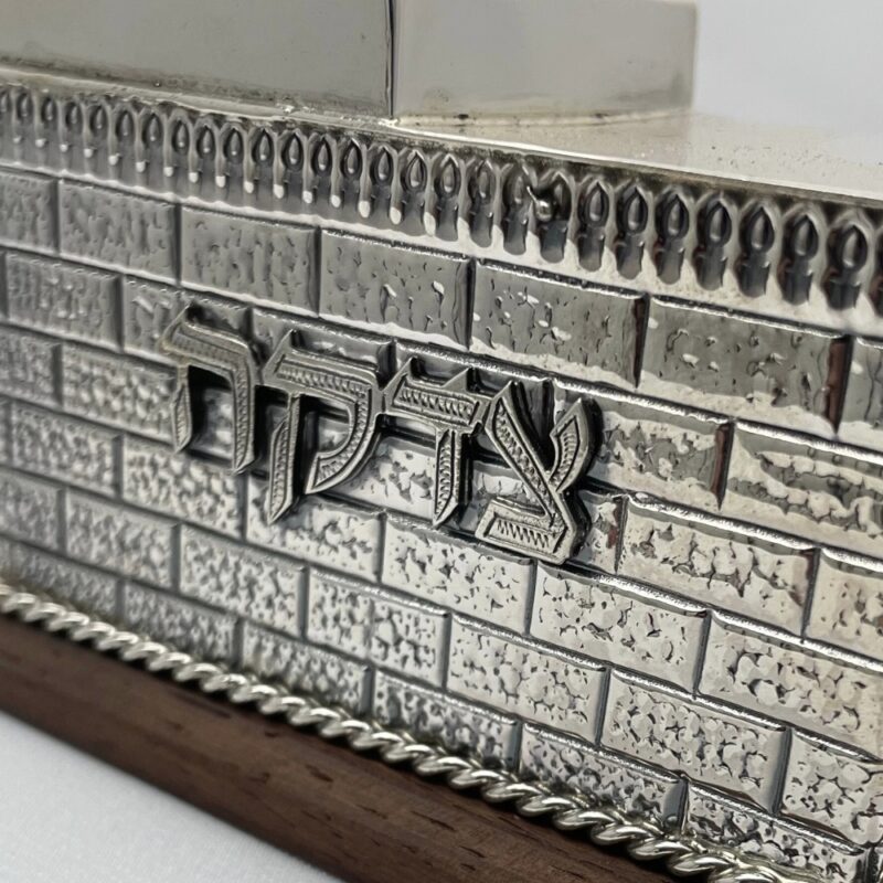Sterling Silver Tzedakah Box with engraved Hebrew text on Western Wall background