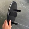 Underside of the Seder plate showing the smooth black wooden base and sturdy legs