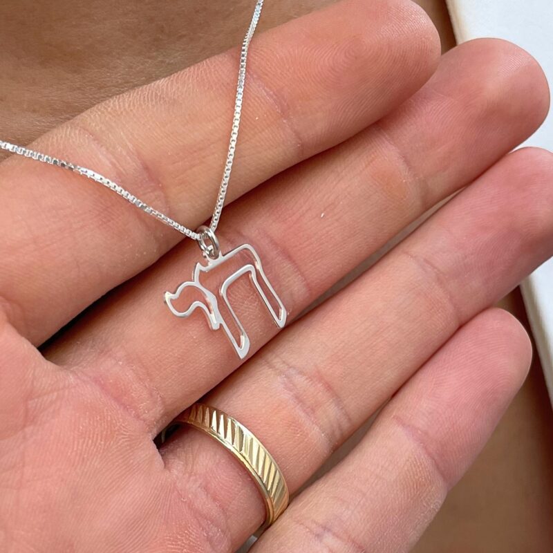 14K White Gold Chai outline pendant necklace held in hand