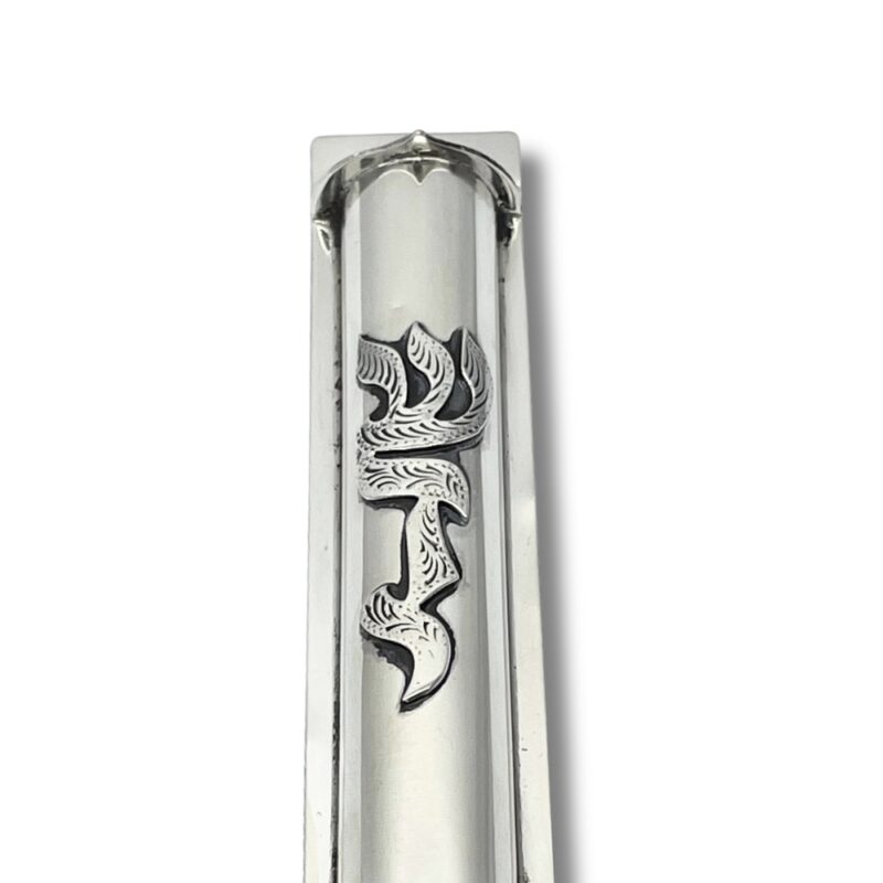 Zoomed-in close-up of the “Shaddai” engraving on the front of the mezuzah case, showing intricate linework and silver finish