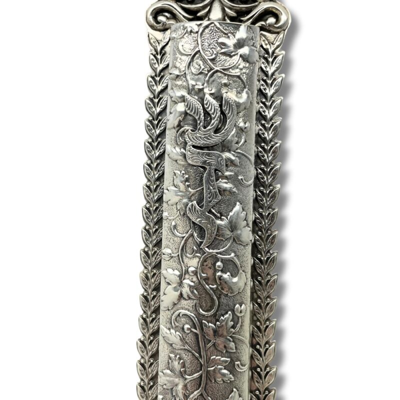 Close-up of handcrafted filigree and embossed Shaddai motif on sterling silver mezuzah case